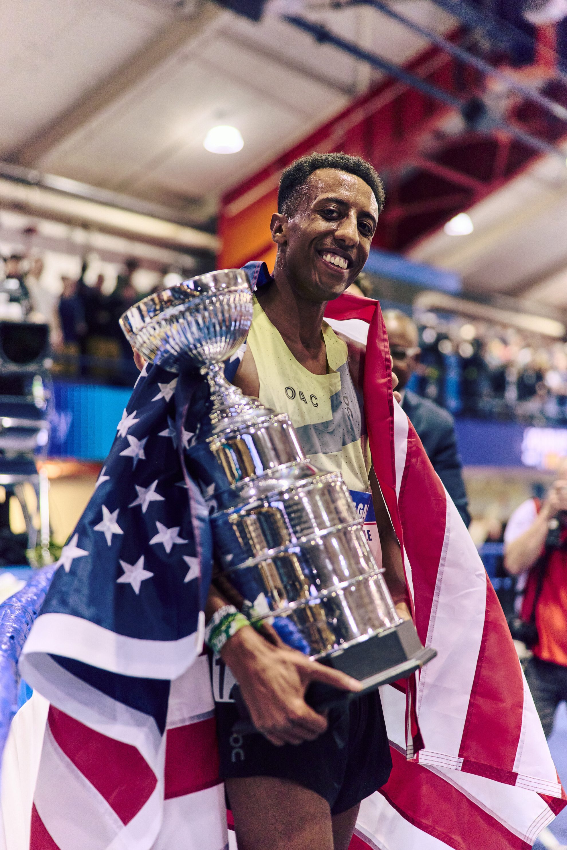 12 Jared Nuguse with Wanamaker Mile trophy and US flag